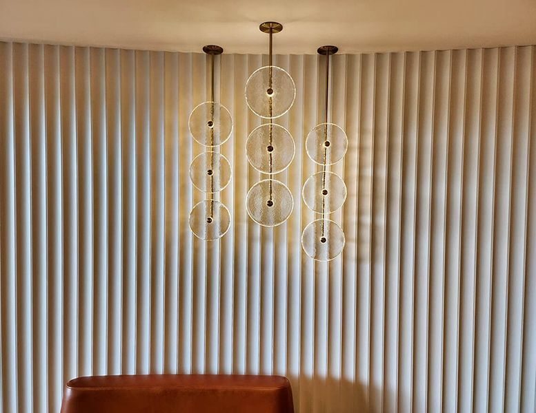 A Living Room with A Couch and A Chandelier Hanging from The Ceiling — Tony Di Milia Flooring in Unanderra, NSW