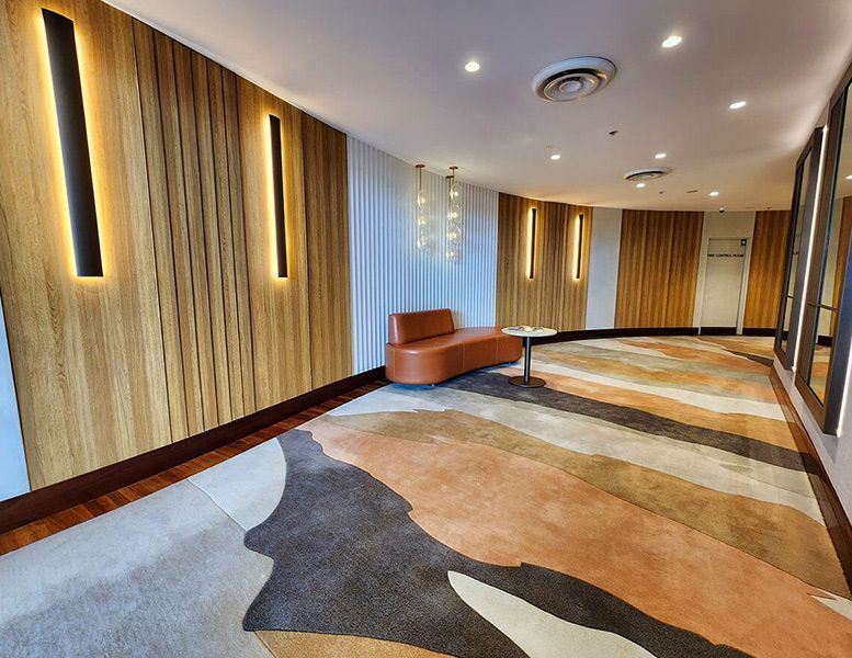 A Long Hallway with A Couch and A Rug — Tony Di Milia Flooring in Unanderra, NSW