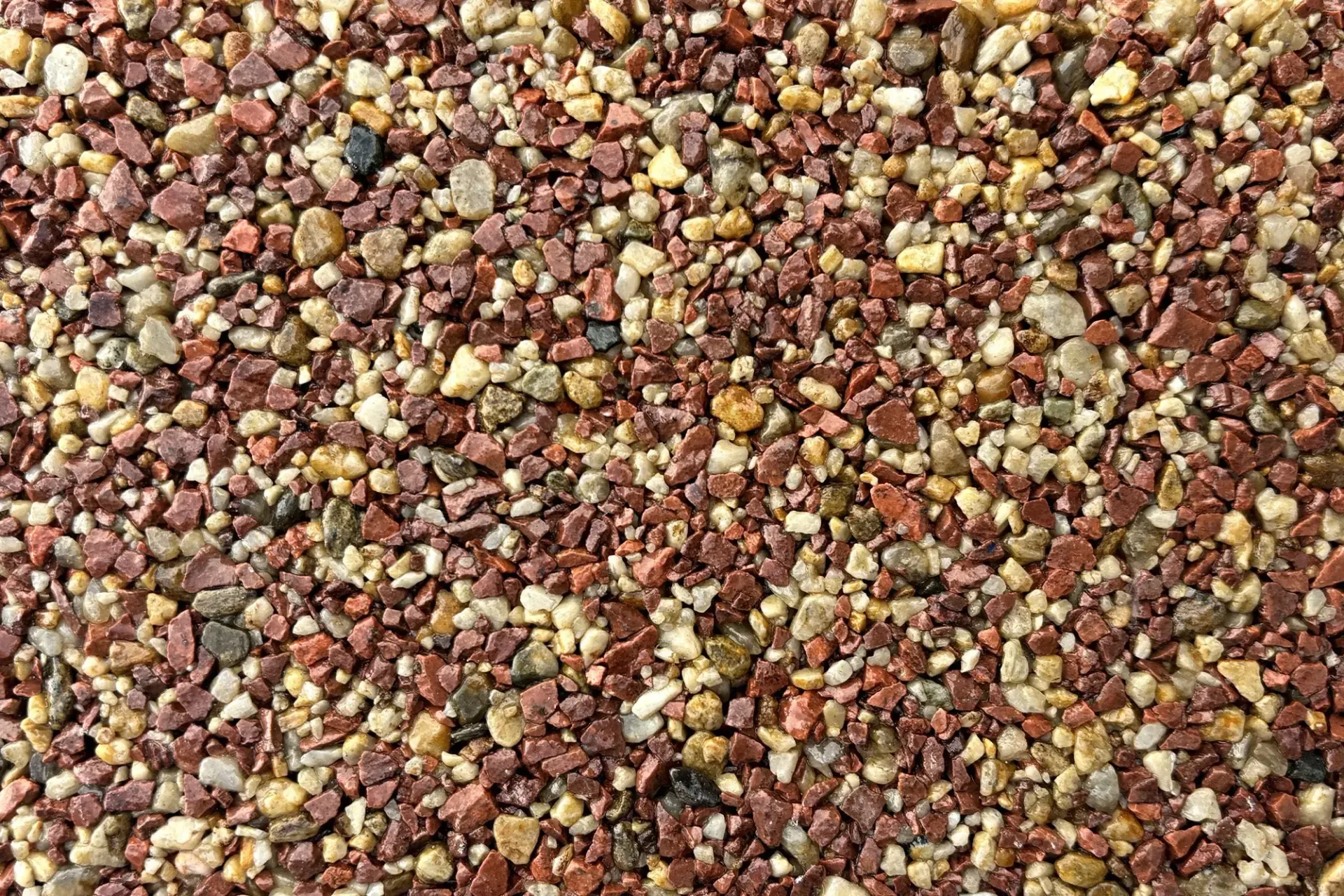 A brick house with a garage and a resin driveway featuring a large, decorative white star inlay.