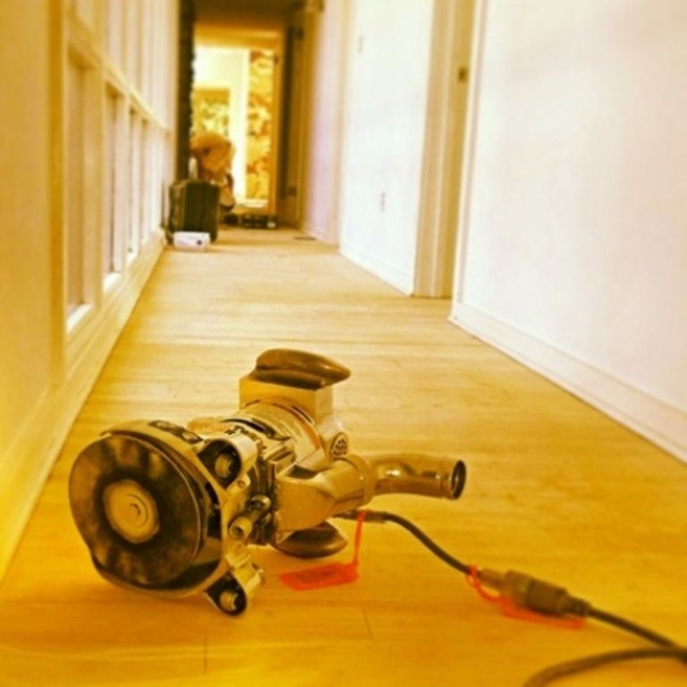 A vacuum cleaner is laying on the floor in a hallway