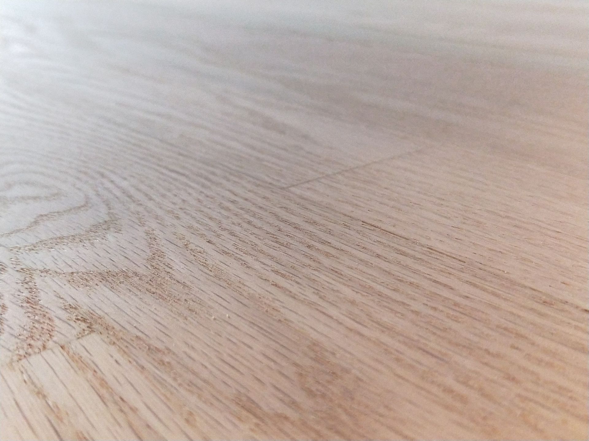 A close up of a wooden floor with a grain pattern