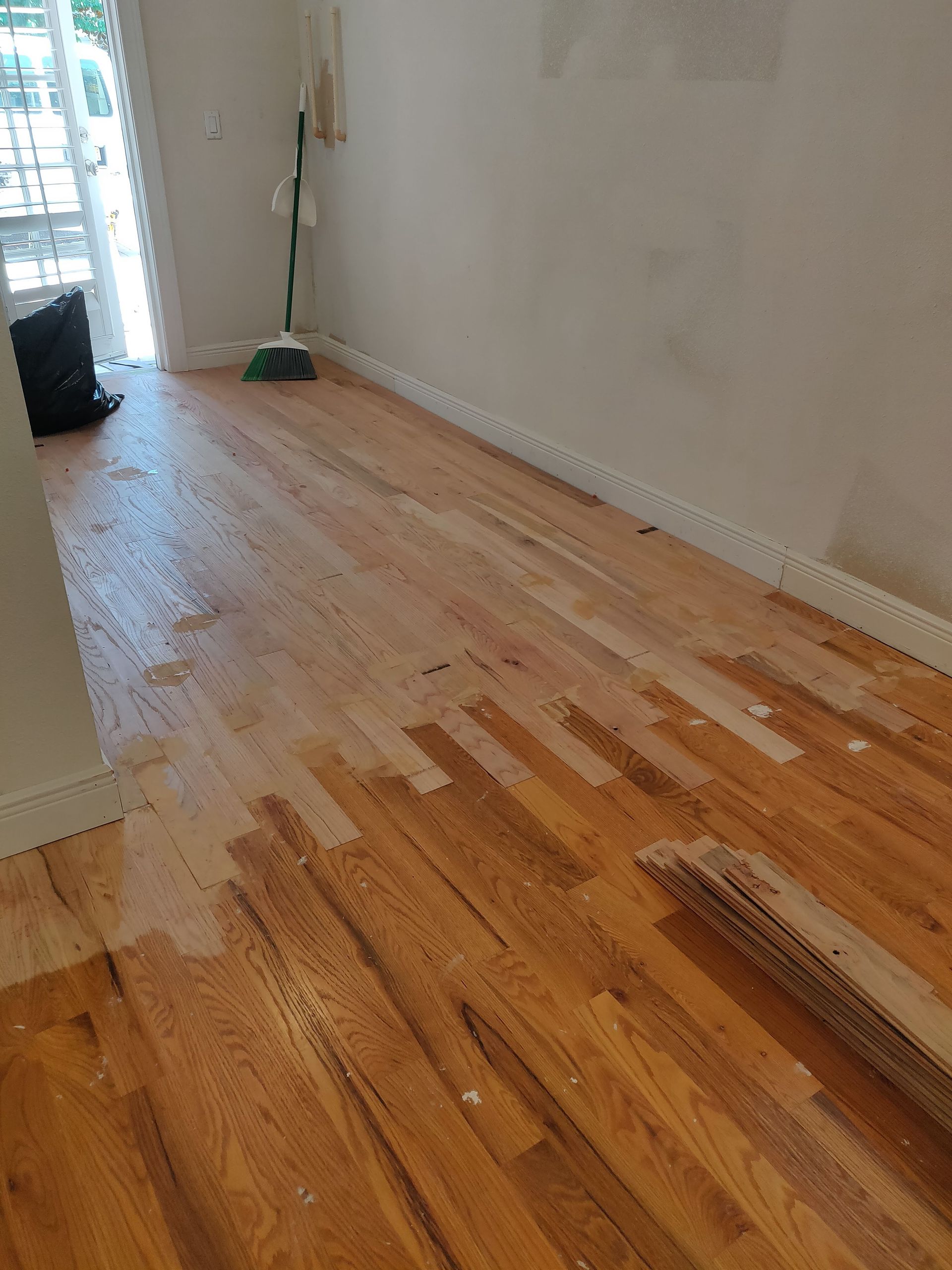 Wooden floor is being painted in a room
