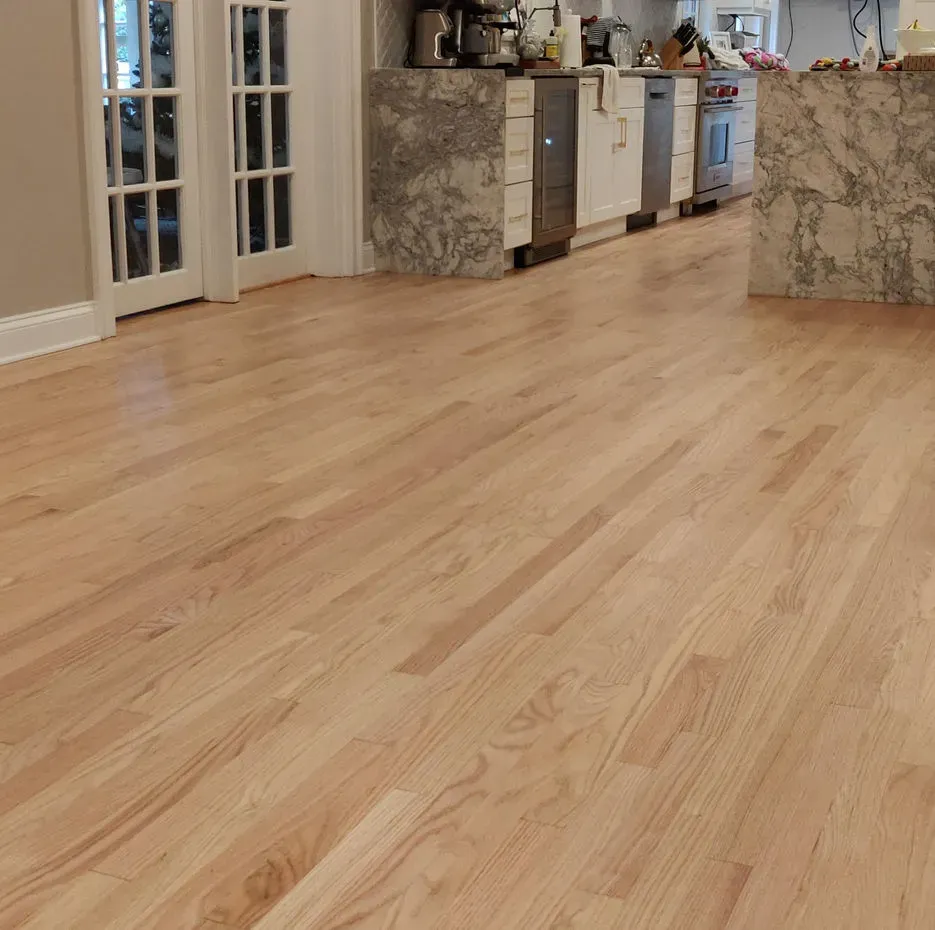 A kitchen with hardwood floors and stainless steel appliances