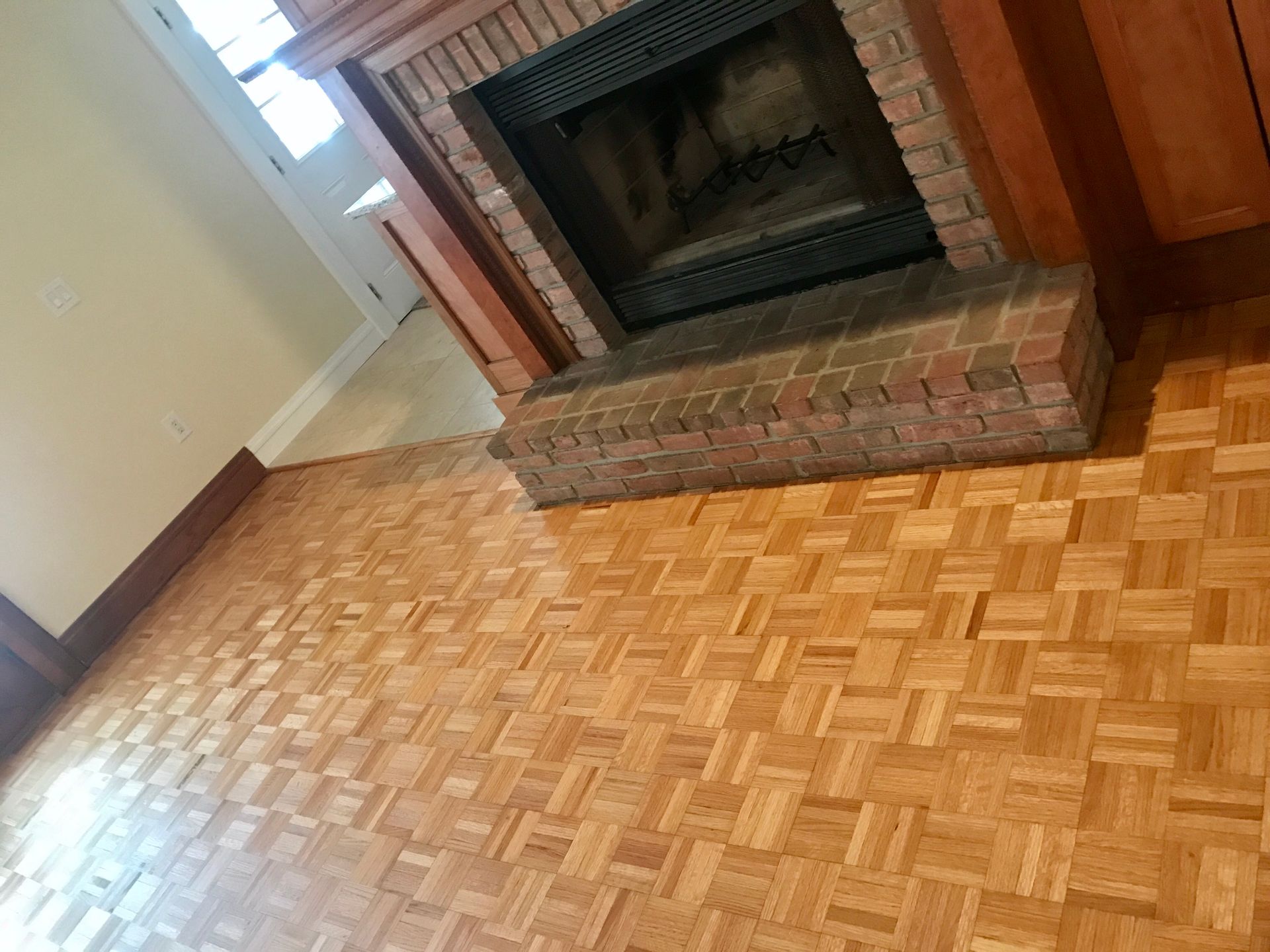 A living room with a fireplace and a wooden floor