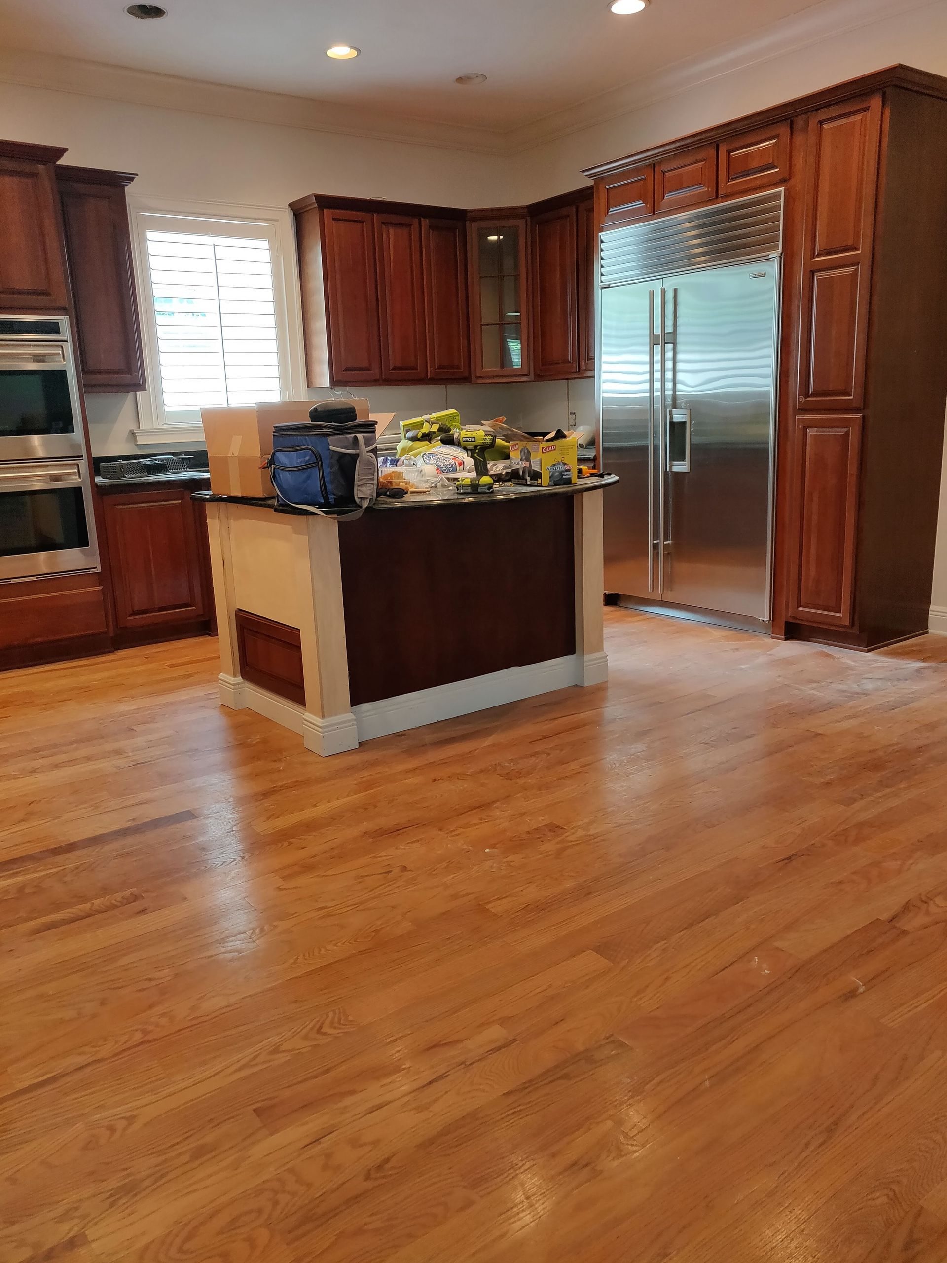 A kitchen with hardwood floors and stainless steel appliances
