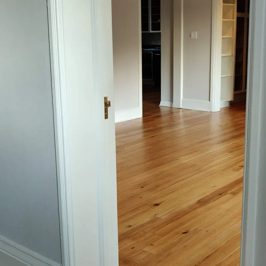A room with hardwood floors and white walls