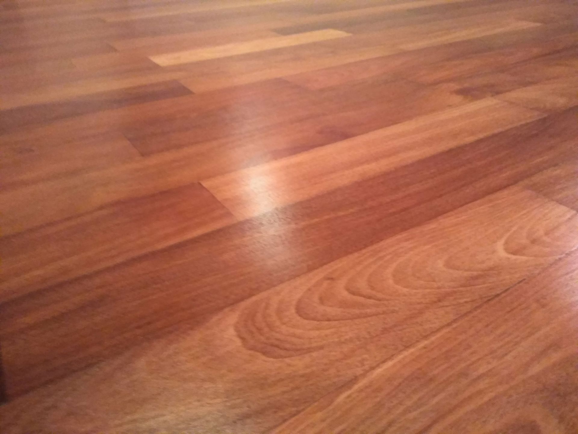 A close up of a wooden floor with a light shining on it