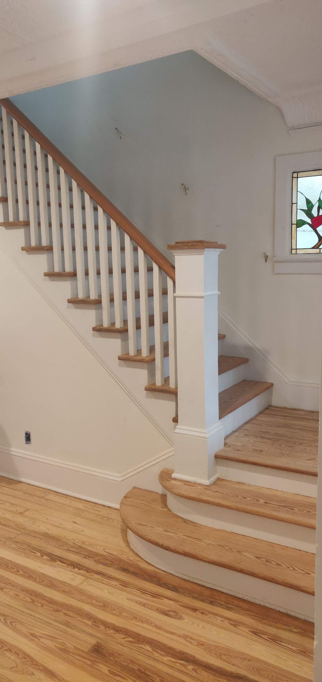 A staircase with wooden steps and a white railing