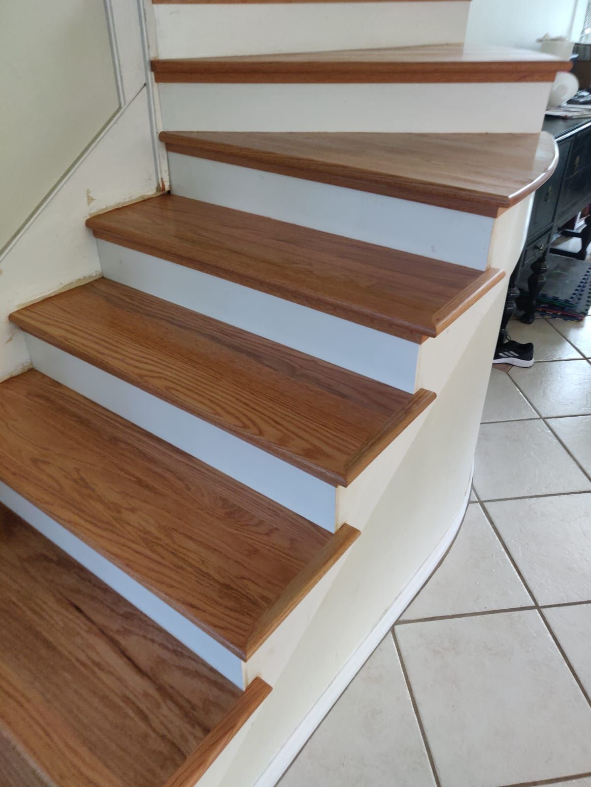 A staircase with wooden steps and white risers in a house