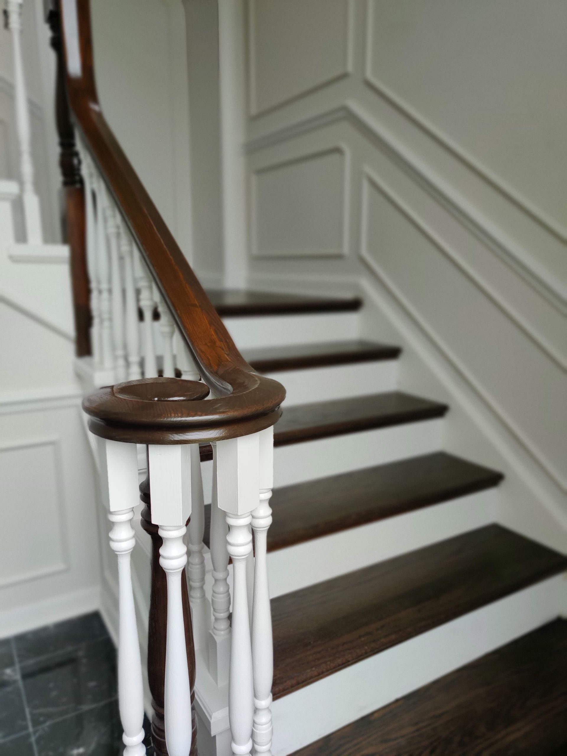 A staircase with wooden steps and a white railing