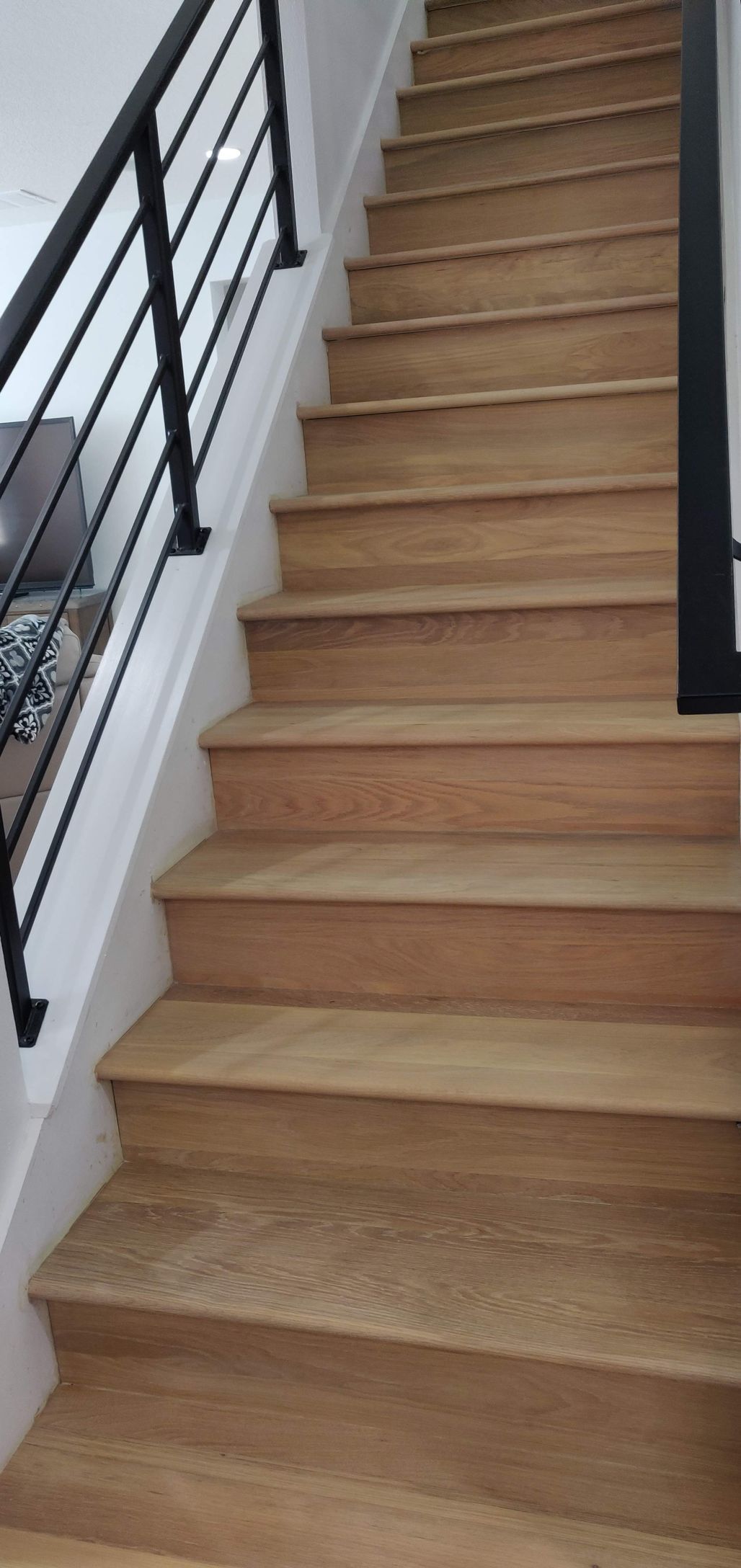 Wooden staircase with a black railing