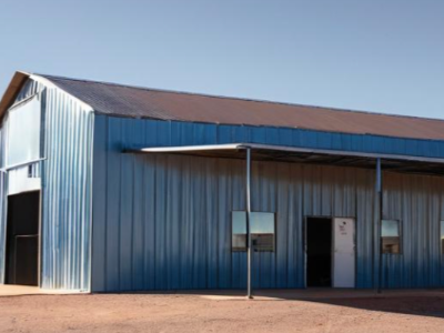 A blue metal building with a brown roof