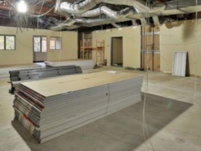 A stack of drywall sheets in a room under construction