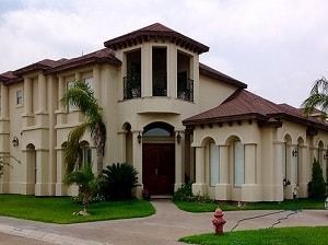A large house with a fire hydrant in front of it.