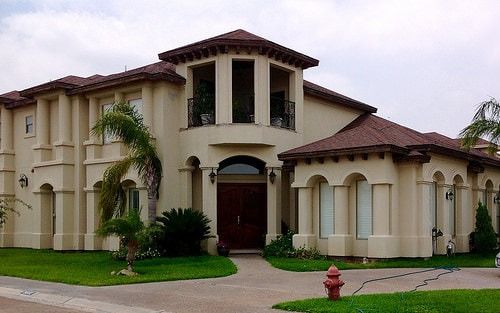 A large house with a fire hydrant in front of it