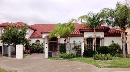 A large white house with a red tile roof