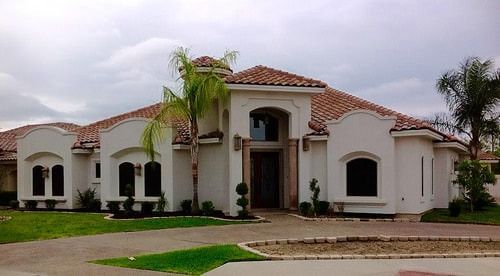 A large white house with a red tile roof