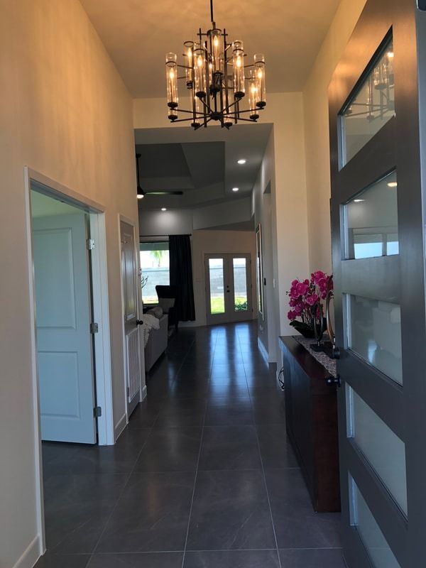 A long hallway with a chandelier hanging from the ceiling