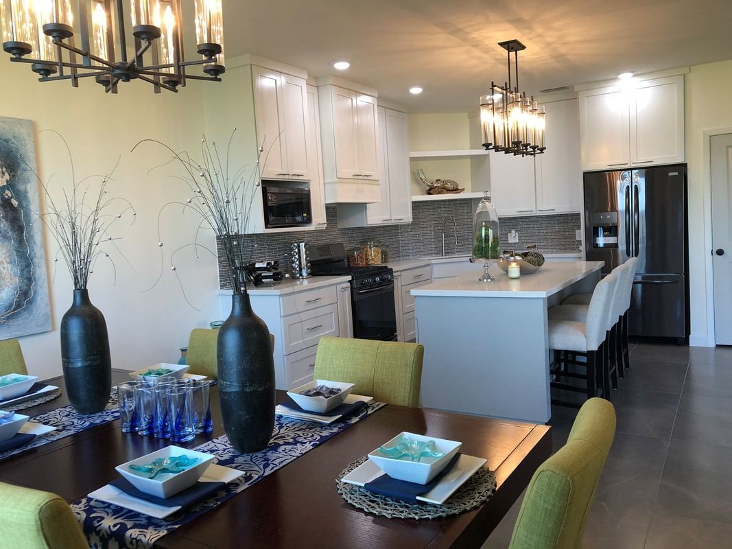A kitchen and dining room in a house with a table and chairs