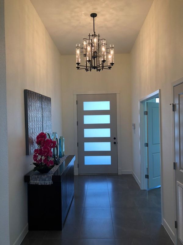 A hallway with a chandelier hanging from the ceiling