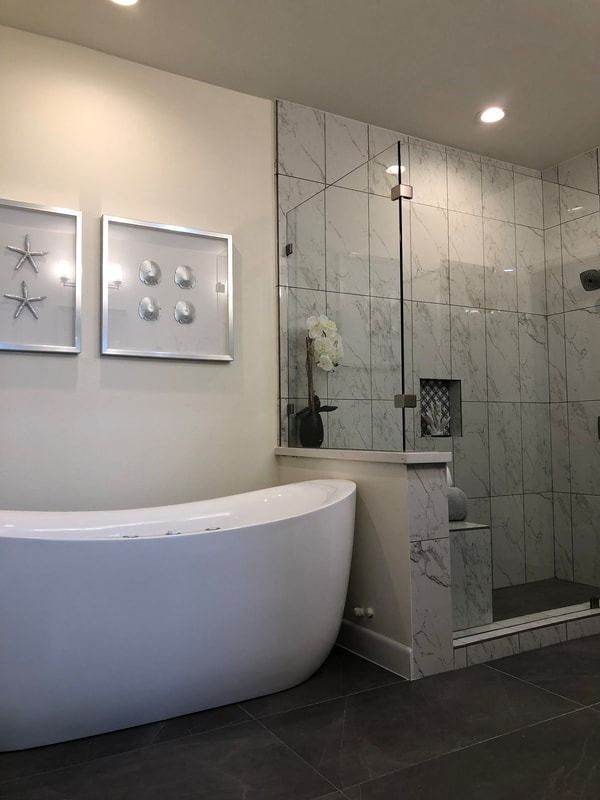 A bathroom with a bathtub and a walk in shower.