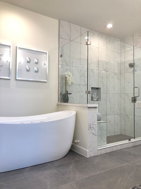 A bathroom with a bathtub and a walk in shower.