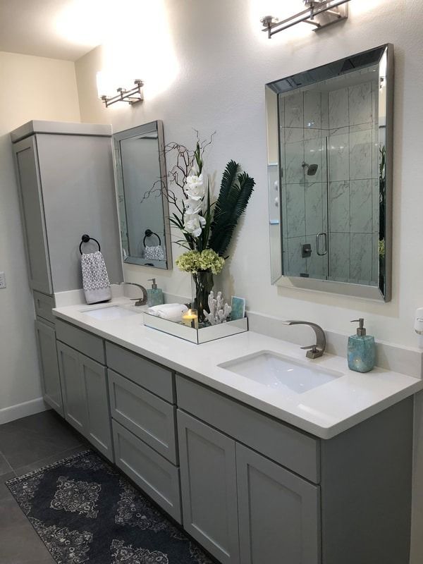 A bathroom with two sinks and two mirrors.