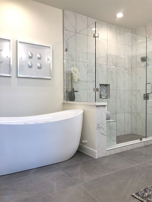 A bathroom with a bathtub and a walk in shower.