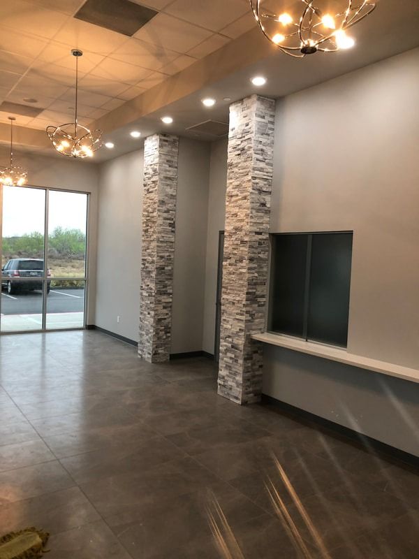 A large empty room with columns and a window.