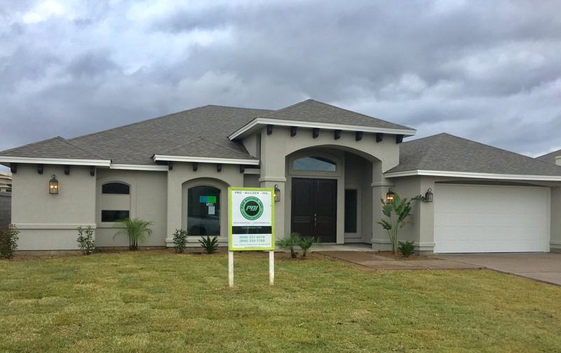 A house with a for sale sign in front of it.