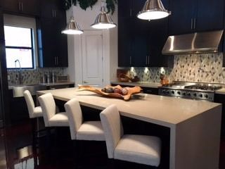 A kitchen with a large island and stainless steel appliances