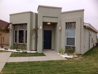 A house with a lot of windows and a blue door