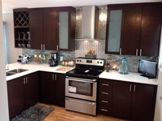A kitchen with stainless steel appliances and wooden cabinets