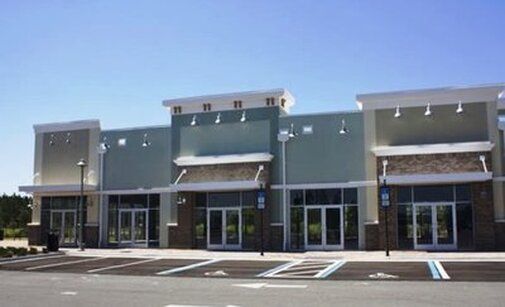 A large building with a parking lot in front of it