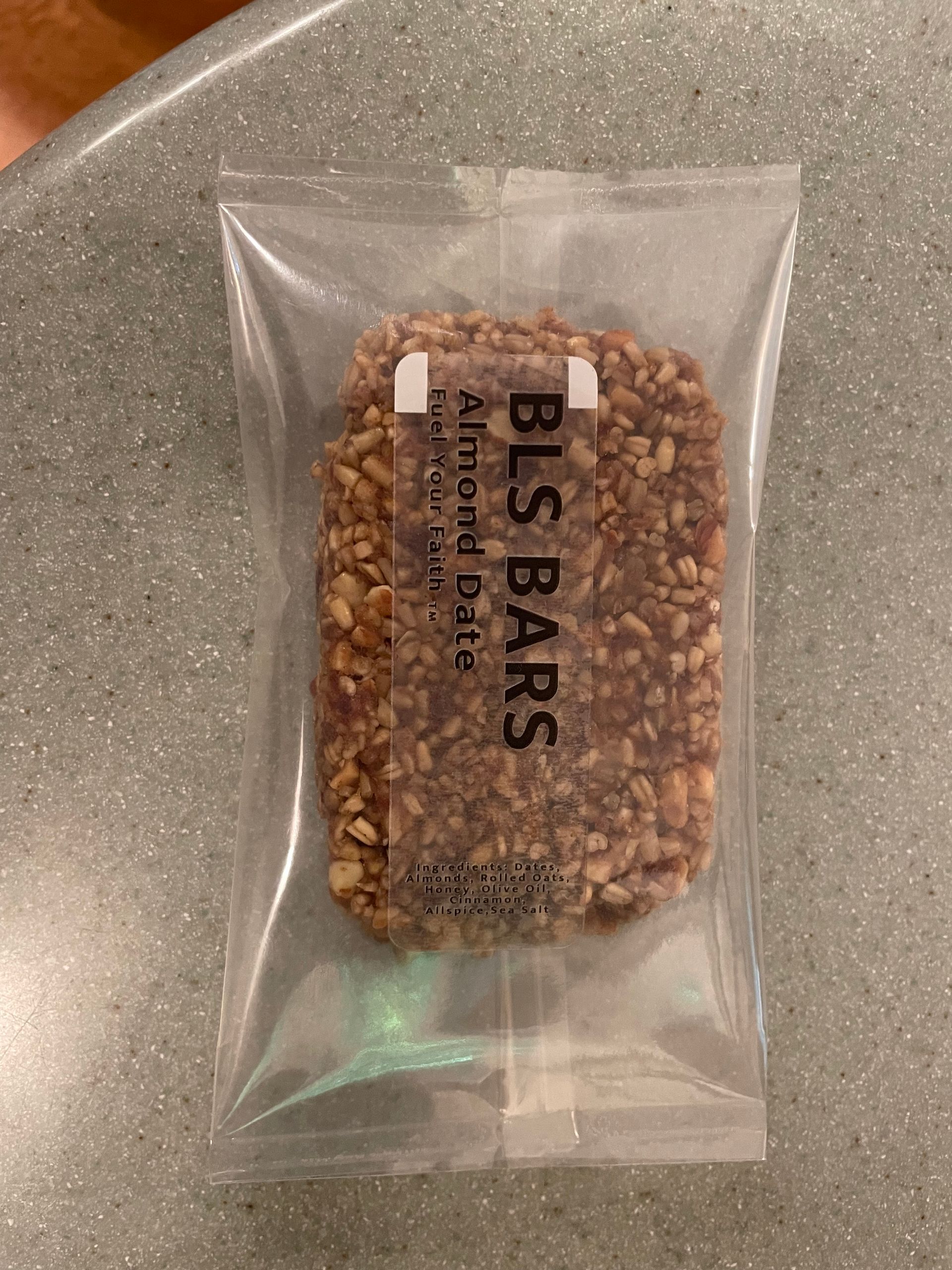 BLS Bars almond date snack in a clear wrapper.