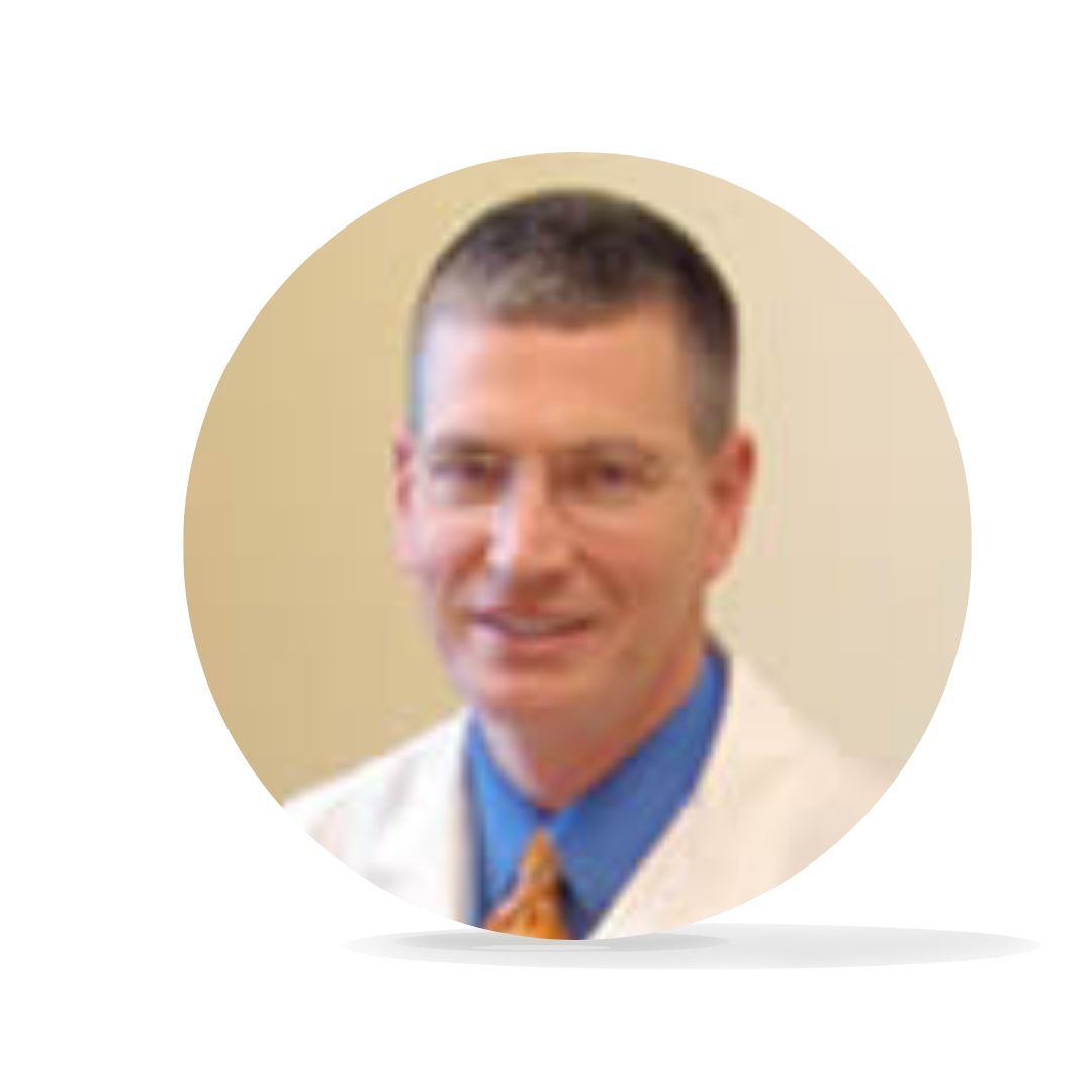 Man in glasses and blue shirt smiles, wearing a white coat, in a circular frame.