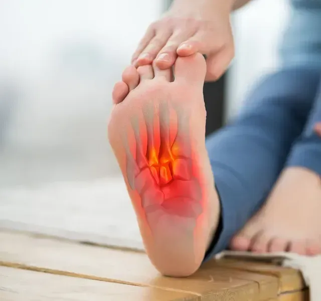 Foot with highlighted red area indicating pain; person touching foot.