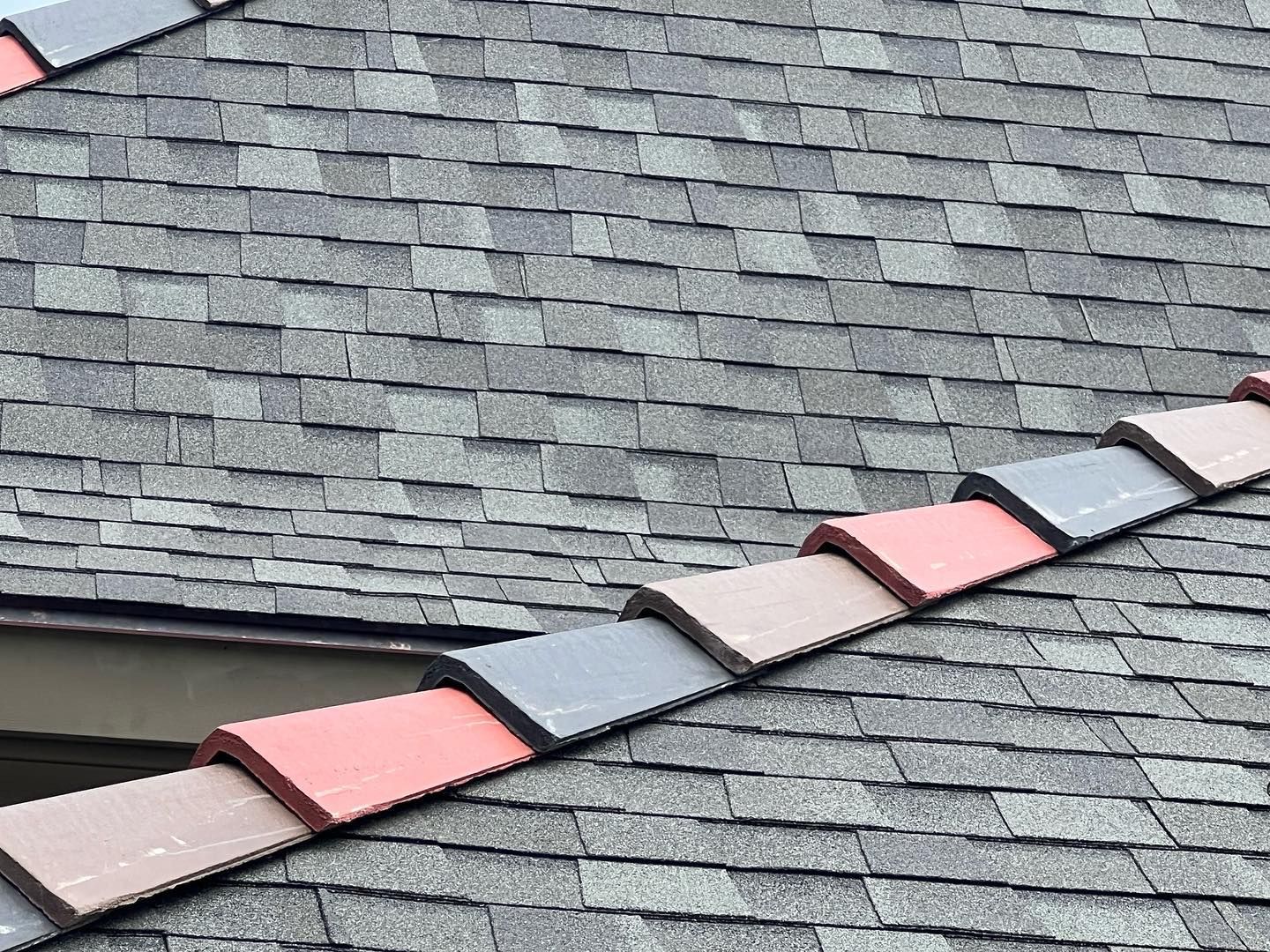 A close up of a roof with a row of tiles on it.