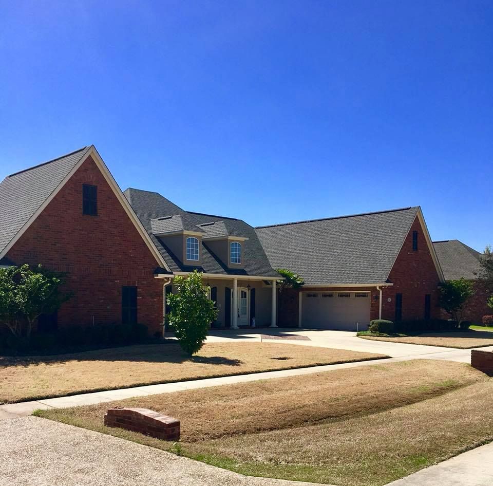 A large brick house with a gray roof