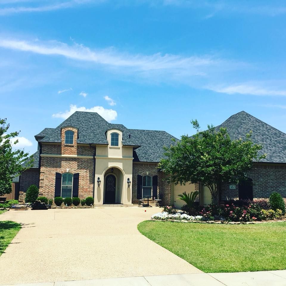 A large brick house with a gray roof