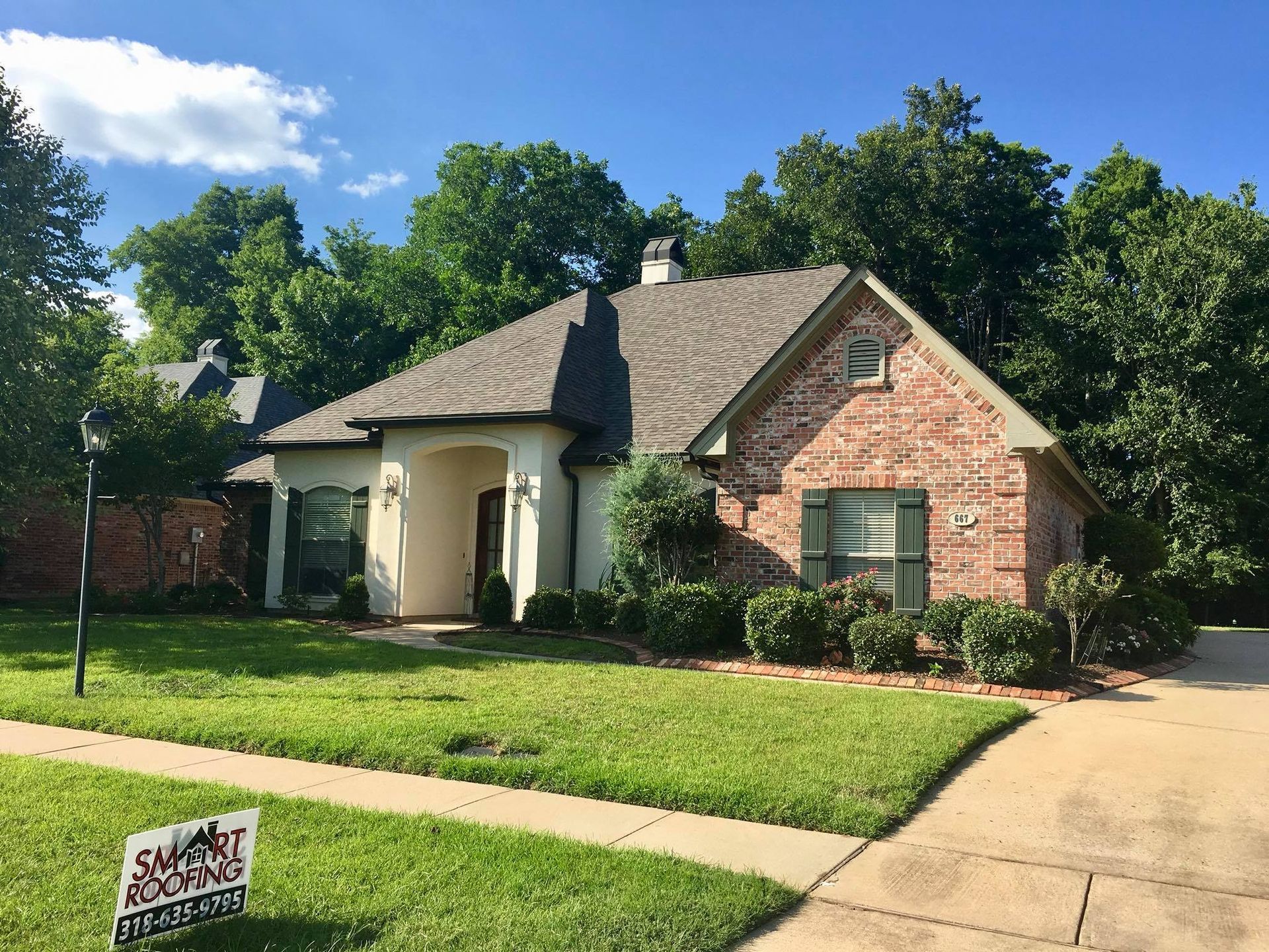 A brick house with a sign in front of it that says houston