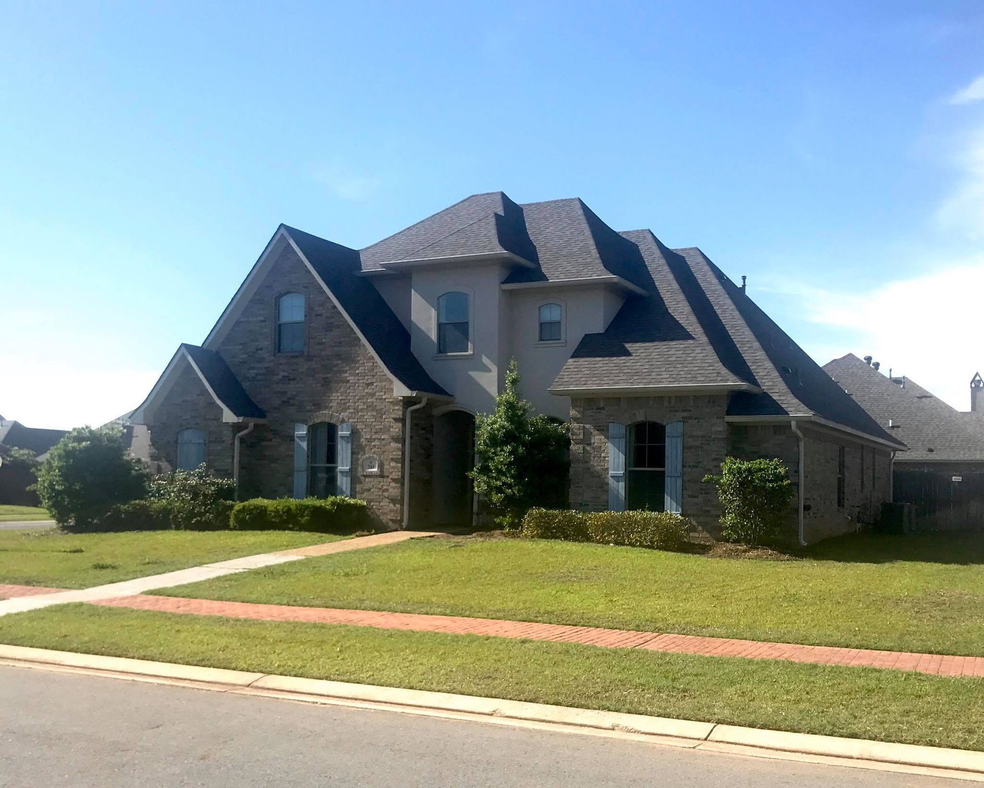 A large brick house with a gray roof