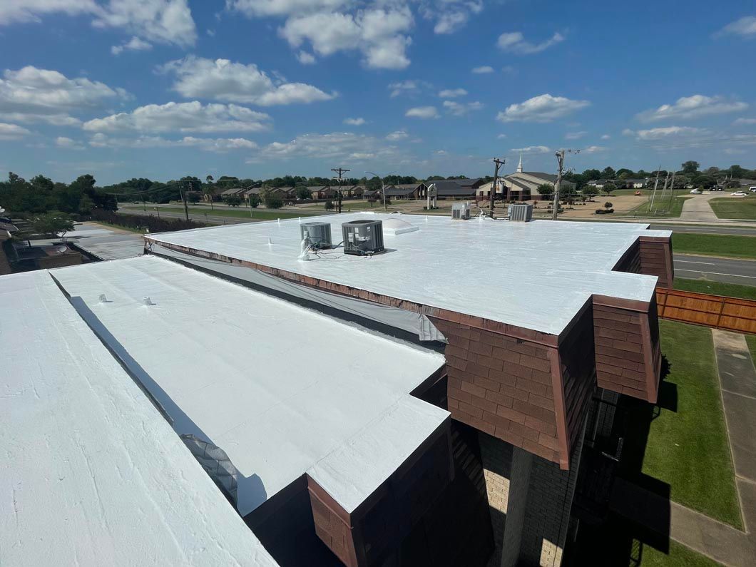 An aerial view of a building with a white roof