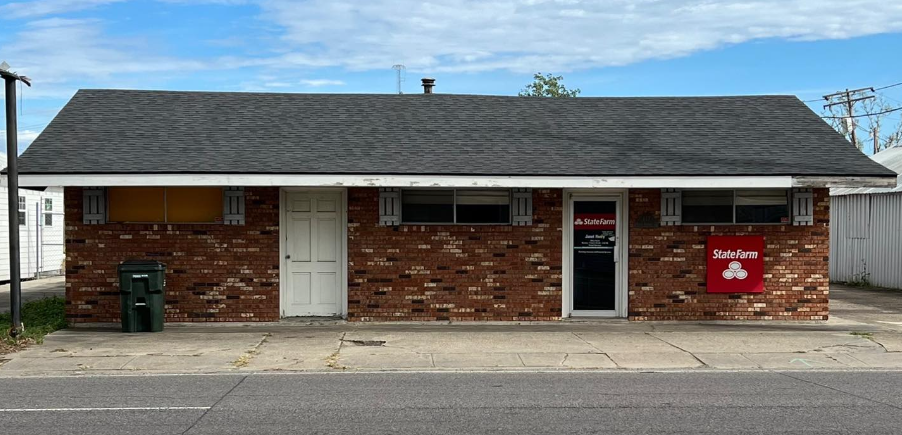 A small brick building with a red box on the side of it.
