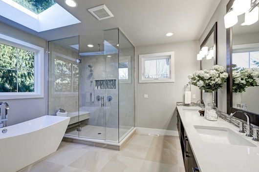 Spacious bathroom in gray tones with heated floors 