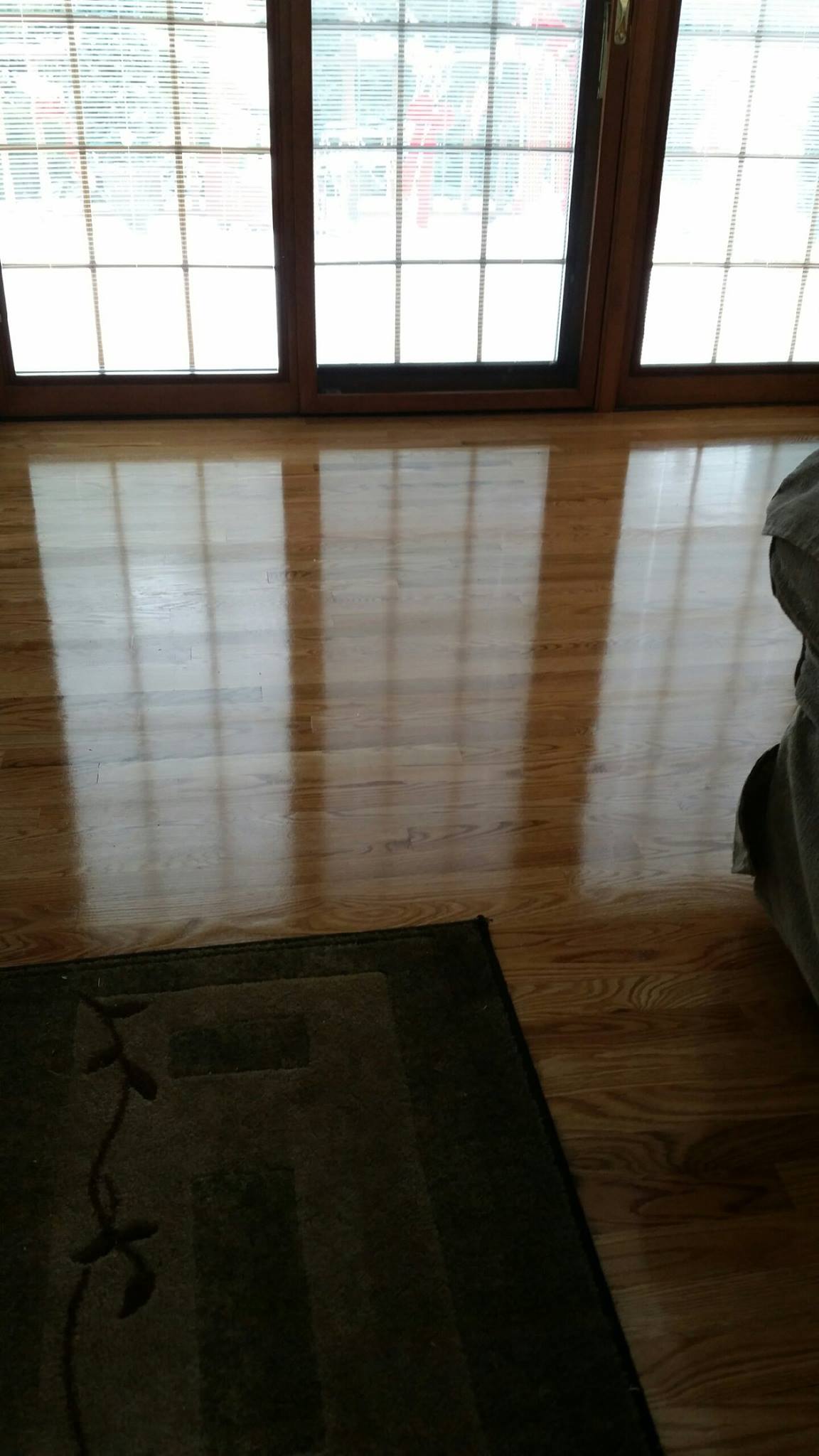 A living room with hardwood floors and sliding glass doors