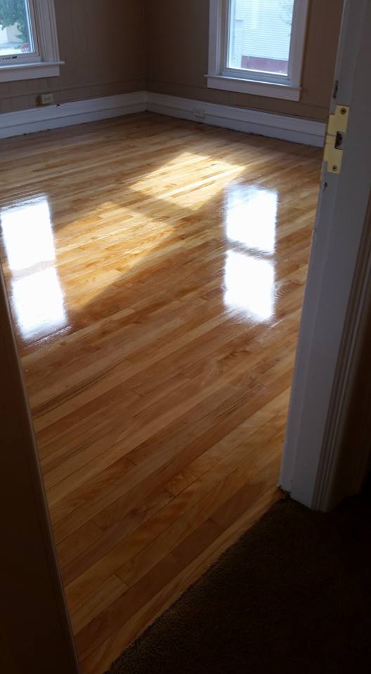 A room with a wooden floor and a window.