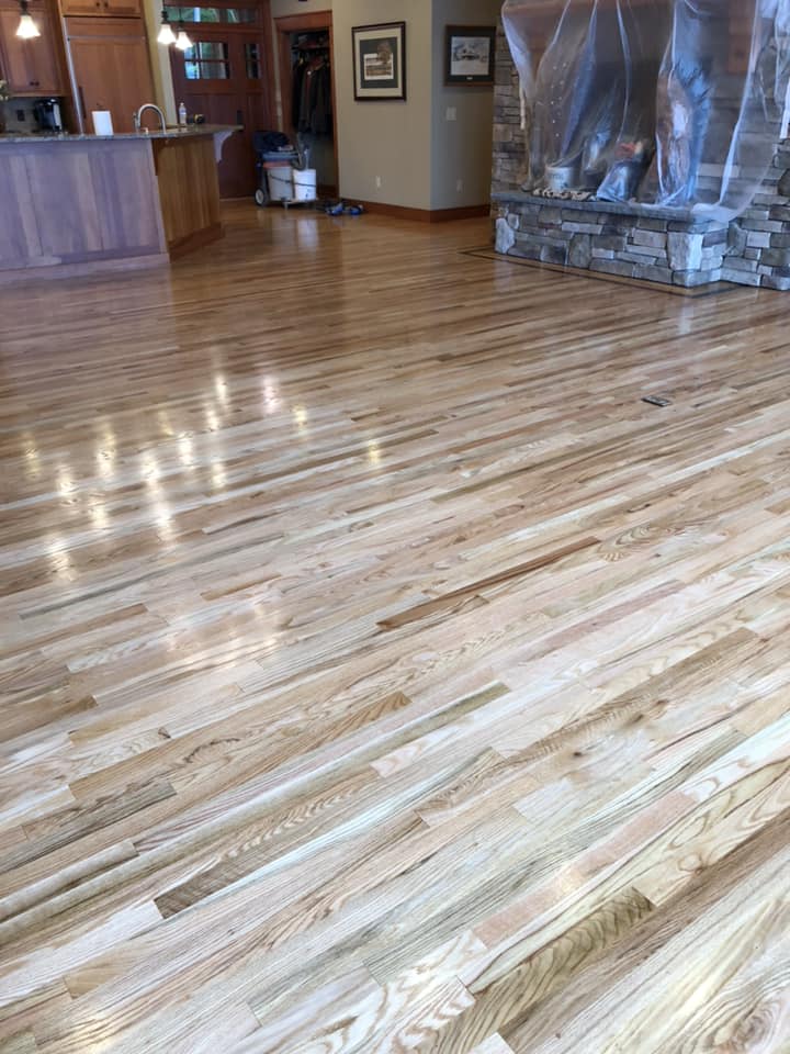 A living room with hardwood floors and a fireplace.