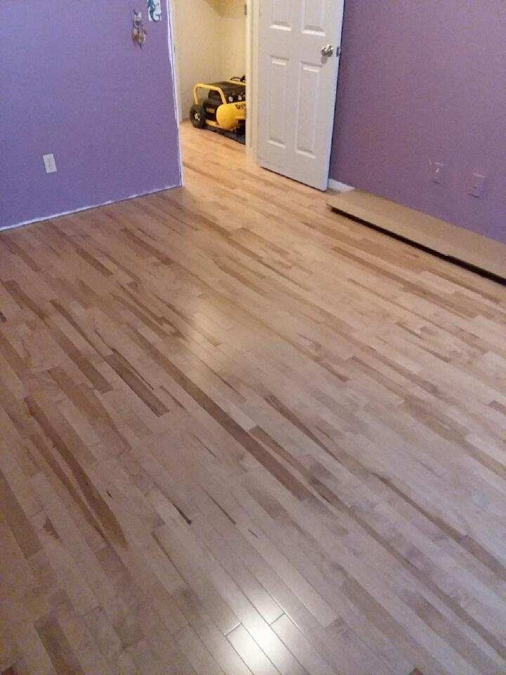 A room with hardwood floors and purple walls