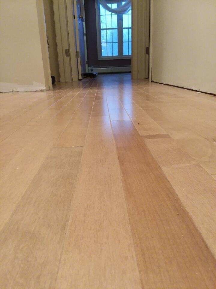 A wooden floor in a room with a window.